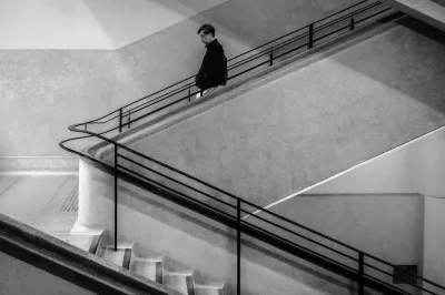 DSCF3966(1) Monochrome image of man decending staircase in Central Market of Hong Kong Island. Staircase was made famous by photographer Fan Ho